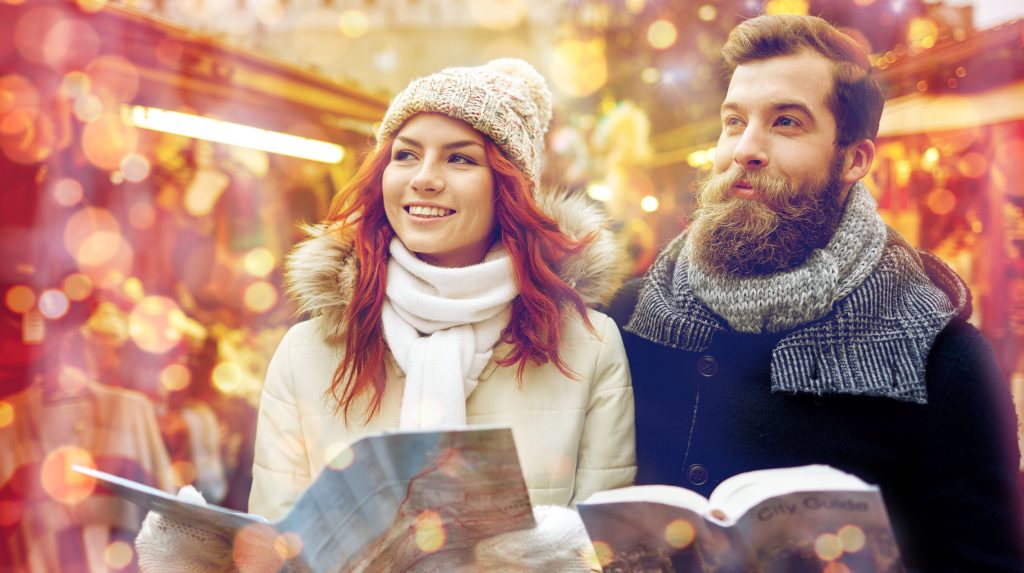 64886896 - holidays, winter, christmas, tourism and people concept - happy couple in warm clothes with map and city guide in old town